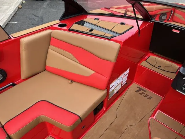 Slide: The Image of 2024 Axis Wake Research T235 boat interior with red and tan seating. - 7