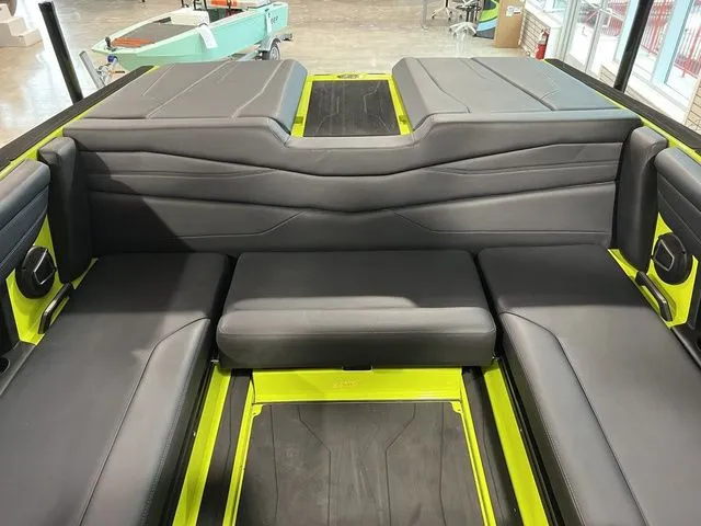 Slide: The Image of 2024 Axis Wake Research A245 boat interior with sleek black seating and vibrant accents. - 10
