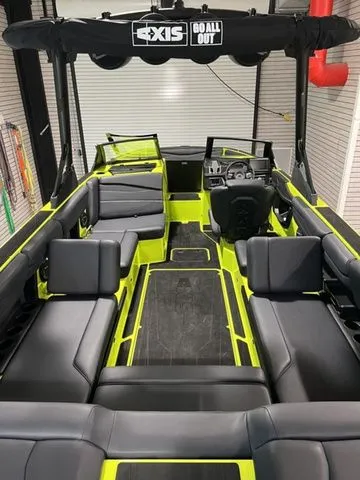 Slide: The Image of 2024 Axis Wake Research A245 boat interior with sleek black and neon accents. - 9