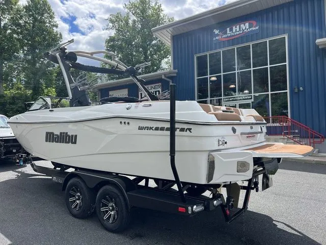 Slide: The Image of 2024 Malibu 23 LSV boat on trailer outside LHM building. - 11