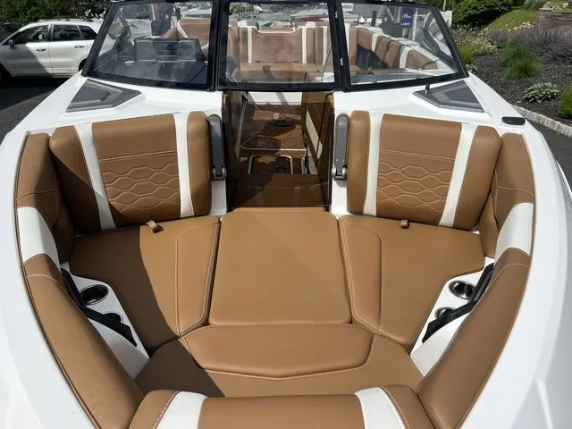 Slide: The Image of 2024 Malibu 23 LSV boat interior with tan and white seating. - 4