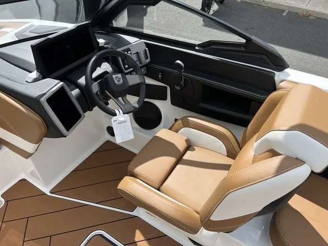 Slide: The Image of 2024 Malibu 23 LSV boat interior with tan leather seats and modern dashboard. - 8