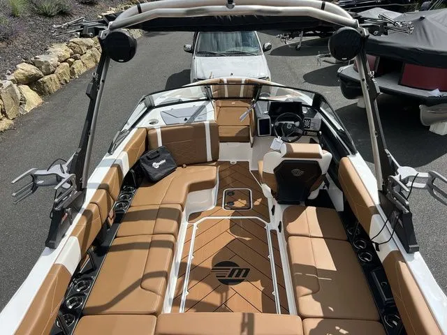 Slide: The Image of 2024 Malibu 23 LSV boat with luxurious tan interior and advanced features. - 9