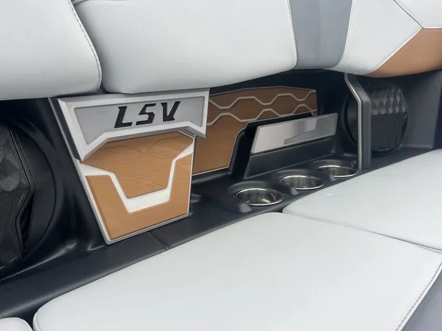 Slide: The Image of 2024 Malibu 23 LSV interior with stylish seating and cup holders. - 11
