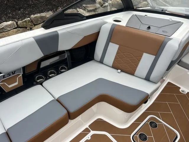 Slide: The Image of 2024 Malibu 23 LSV boat interior with stylish brown and gray seating. - 13