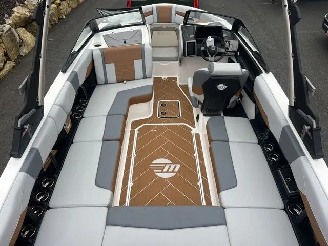 Slide: The Image of 2024 Malibu 23 LSV boat interior with sleek seating and modern dashboard design. - 2