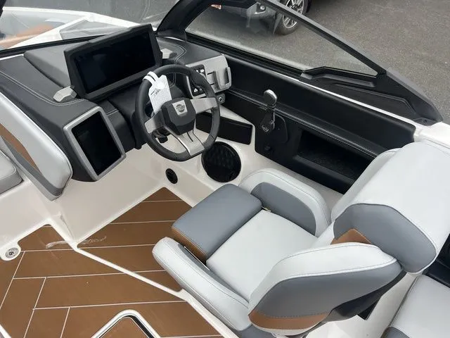 Slide: The Image of 2024 Malibu 23 LSV boat interior with modern dashboard and comfortable seating. - 4