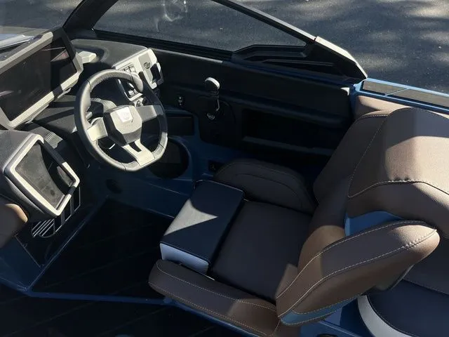 Slide: The Image of 2024 Malibu 23 LSV boat interior with modern dashboard and comfortable seating. - 10