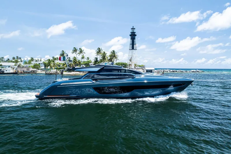 Slide: The Image of 2024 Riva 76 PERSEO Super yacht cruising near a lighthouse on a sunny day. - 11