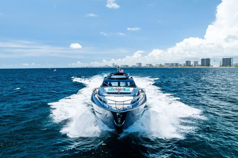 Slide: The Image of 2024 Riva 76 PERSEO Super yacht cruising on open sea with city skyline backdrop. - 3