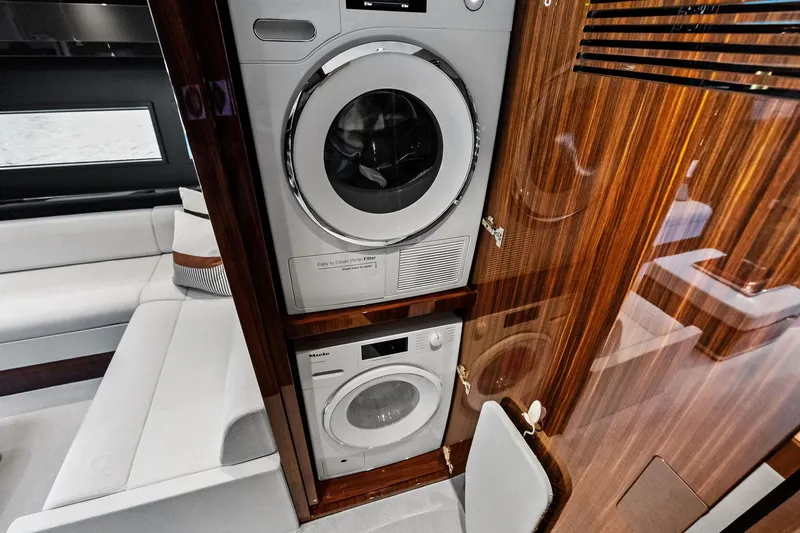 Slide: The Image of Laundry area inside 2024 Riva 76 PERSEO Super yacht with modern appliances and wood paneling. - 66