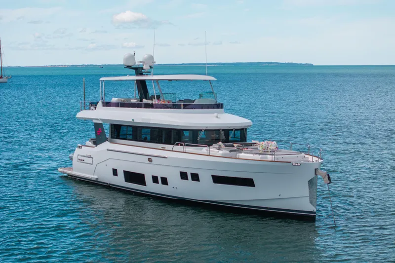 Slide: The Image of Luxurious 2019 Sirena 64 yacht cruising on calm blue waters. - 10