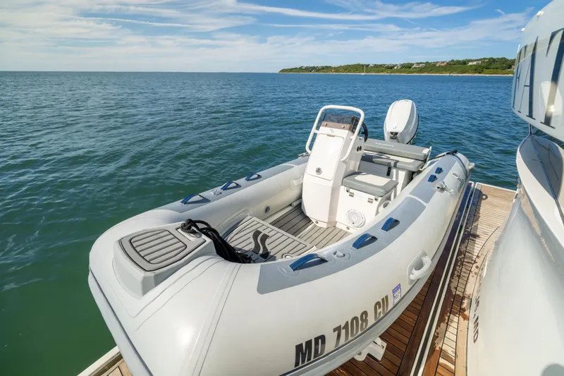 Slide: The Image of Inflatable boat docked on a Sirena 64 yacht, 2019 model, with scenic ocean view. - 13