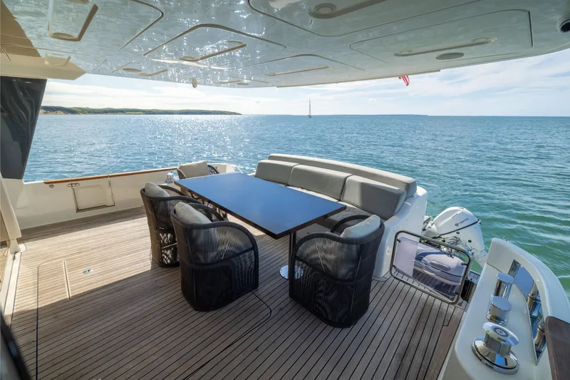 Slide: The Image of Luxurious 2019 Sirena 64 yacht deck with ocean view and elegant seating area. - 17