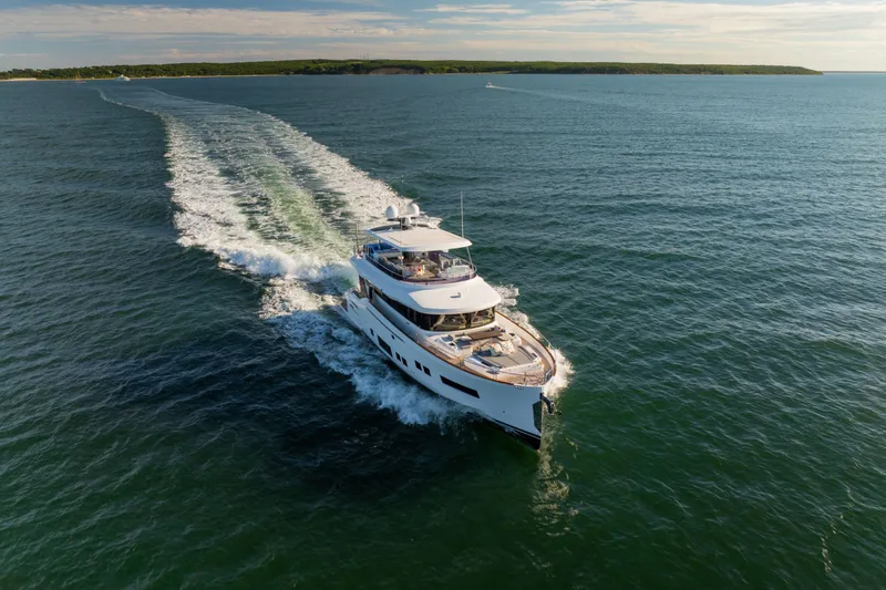 Slide: The Image of Luxurious 2019 Sirena 64 yacht cruising on open water under a clear sky. - 2