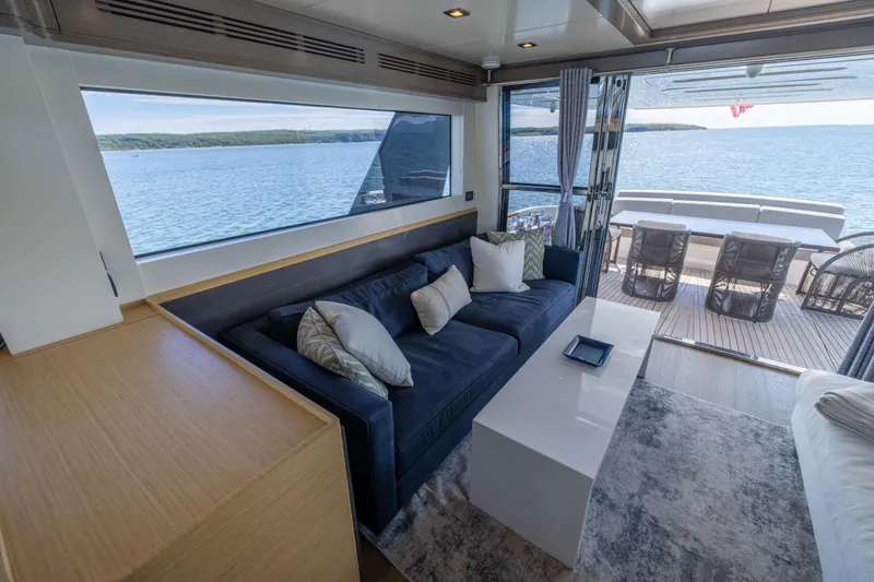 Slide: The Image of Luxurious interior of 2019 Sirena 64 yacht with ocean view and elegant seating area. - 20