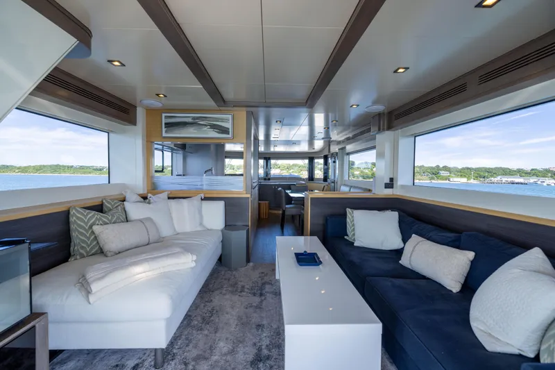 Slide: The Image of Luxurious interior of 2019 Sirena 64 yacht with modern seating and panoramic windows. - 22