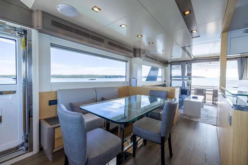 Slide: The Image of Luxurious interior of 2019 Sirena 64 yacht with modern dining area and scenic ocean views. - 26