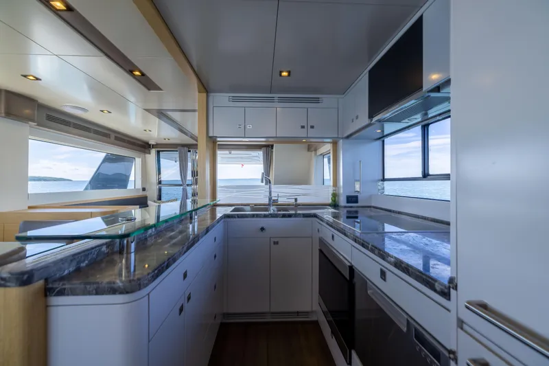 Slide: The Image of Luxurious kitchen interior of 2019 Sirena 64 yacht with modern appliances and ocean view. - 27