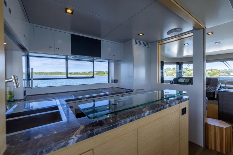 Slide: The Image of Modern kitchen interior on 2019 Sirena 64 yacht with scenic ocean view. - 28