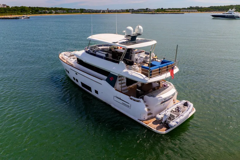 Slide: The Image of Luxurious 2019 Sirena 64 yacht cruising in serene waters, featuring spacious decks and modern design. - 3