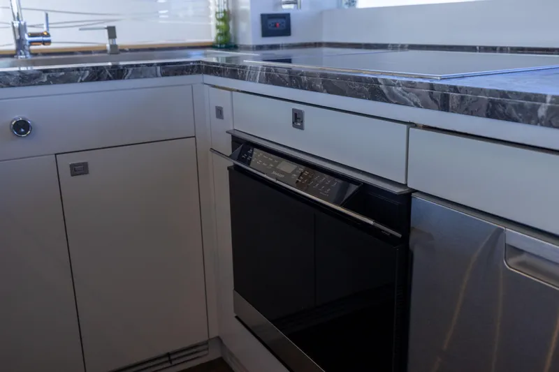 Slide: The Image of Modern kitchen in 2019 Sirena 64 yacht with sleek appliances and marble countertops. - 32