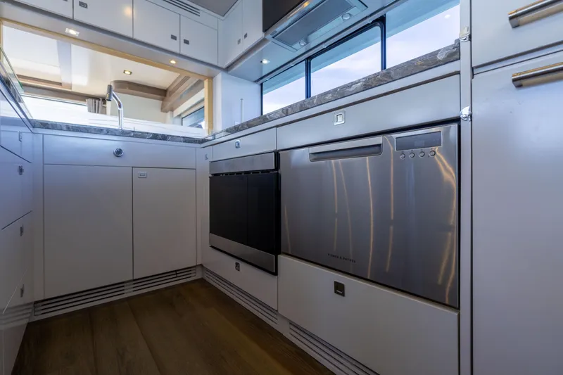 Slide: The Image of Modern kitchen interior on 2019 Sirena 64 yacht, featuring sleek cabinetry and stainless steel appliances. - 33