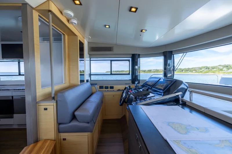 Slide: The Image of 2019 Sirena 64 yacht interior with modern helm, navigation screens, and panoramic windows. - 36