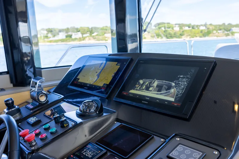 Slide: The Image of Cockpit of 2019 Sirena 64 yacht with navigation screens and controls. - 40