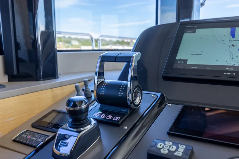Slide: The Image of Cockpit controls of a 2019 Sirena 64 yacht with navigation display. - 41