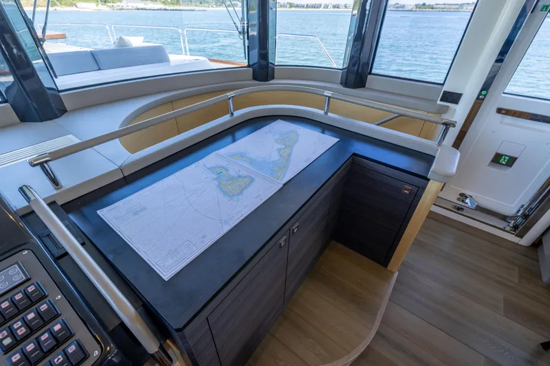 Slide: The Image of Luxurious interior of 2019 Sirena 64 yacht with navigation map on counter. - 45