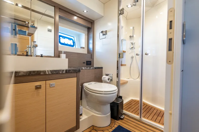 Slide: The Image of Luxurious bathroom in 2019 Sirena 64 yacht with modern fixtures and wooden accents. - 50