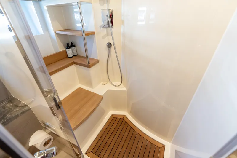 Slide: The Image of Luxurious Sirena 64 yacht shower with wooden accents and modern fixtures, 2019 model. - 52