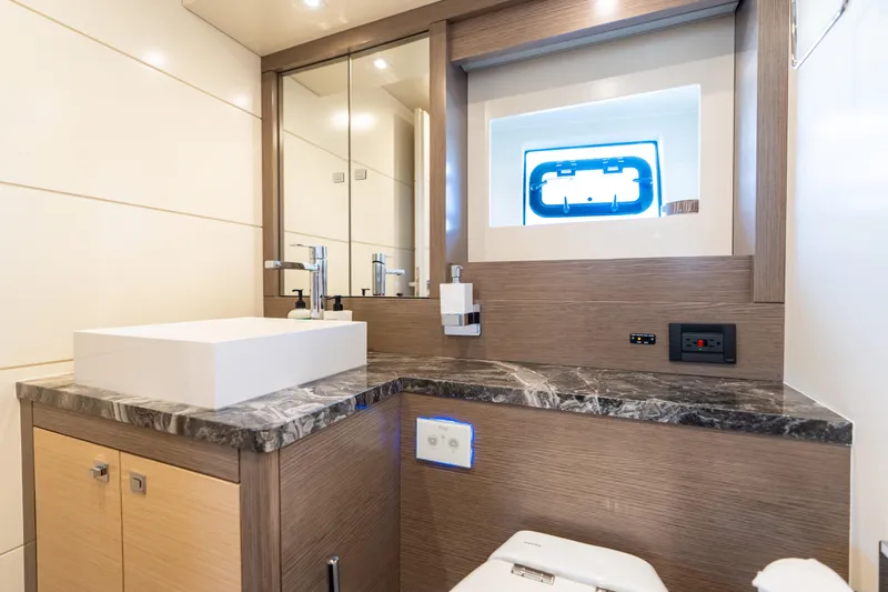 Slide: The Image of Luxurious bathroom interior on 2019 Sirena 64 yacht with modern fixtures and marble countertop. - 53