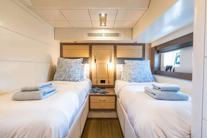 Slide: The Image of Luxurious twin cabin interior on 2019 Sirena 64 yacht, featuring elegant bedding and modern design. - 55