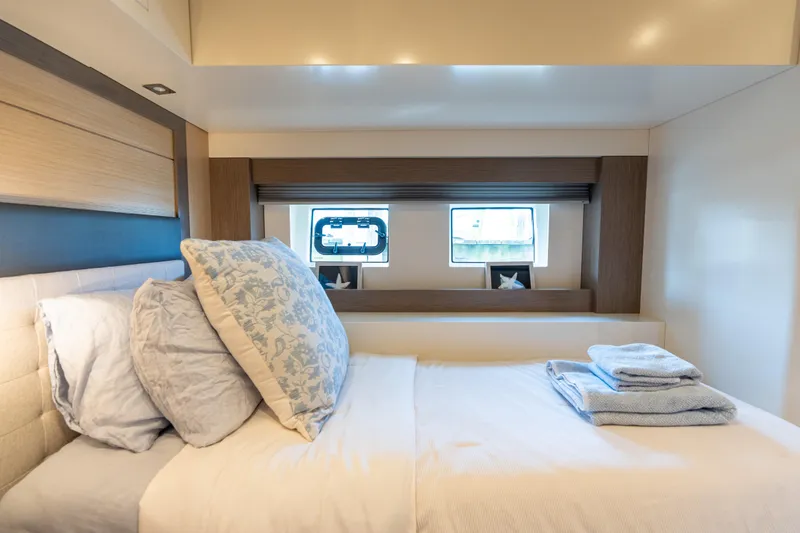 Slide: The Image of Luxurious cabin interior of 2019 Sirena 64 yacht with cozy bedding and window view. - 56