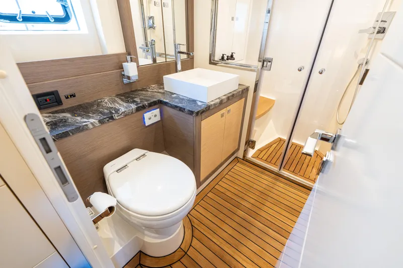 Slide: The Image of Luxurious bathroom in 2019 Sirena 64 yacht with modern fixtures and wooden flooring. - 58