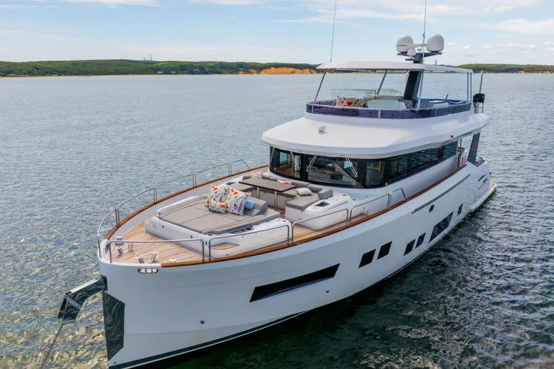Slide: The Image of Luxurious 2019 Sirena 64 yacht cruising on serene waters, featuring spacious deck and modern design. - 6
