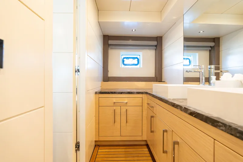 Slide: The Image of Luxurious bathroom interior on 2019 Sirena 64 yacht, featuring modern fixtures and wooden cabinetry. - 66