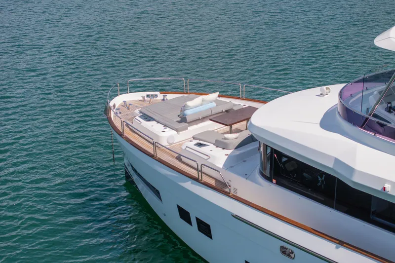 Slide: The Image of 2019 Sirena 64 yacht with spacious deck, cruising on calm blue waters. - 7