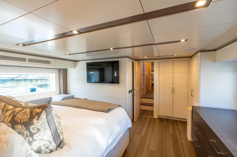 Slide: The Image of Luxurious 2019 Sirena 64 yacht bedroom with modern decor and large window. - 72
