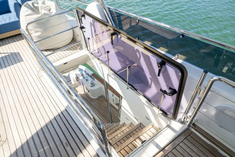 Slide: The Image of Staircase on 2019 Sirena 64 yacht with wooden deck and glass railing. - 78