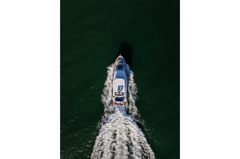 Slide: The Image of Aerial view of 2019 Sirena 64 yacht cruising on open water. - 8
