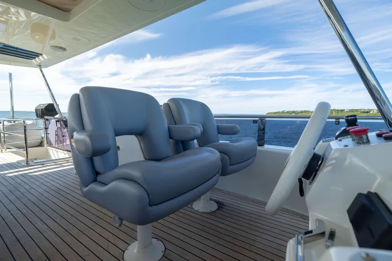 Slide: The Image of Luxury yacht Sirena 64 helm with plush seating, ocean view, and modern controls. - 84