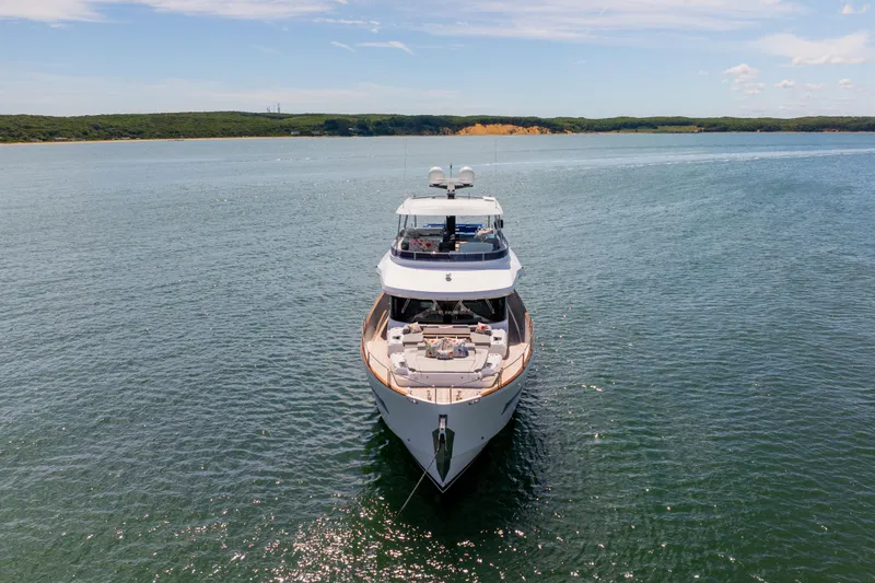 Slide: The Image of Luxurious 2019 Sirena 64 yacht on serene waters under a clear sky. - 9