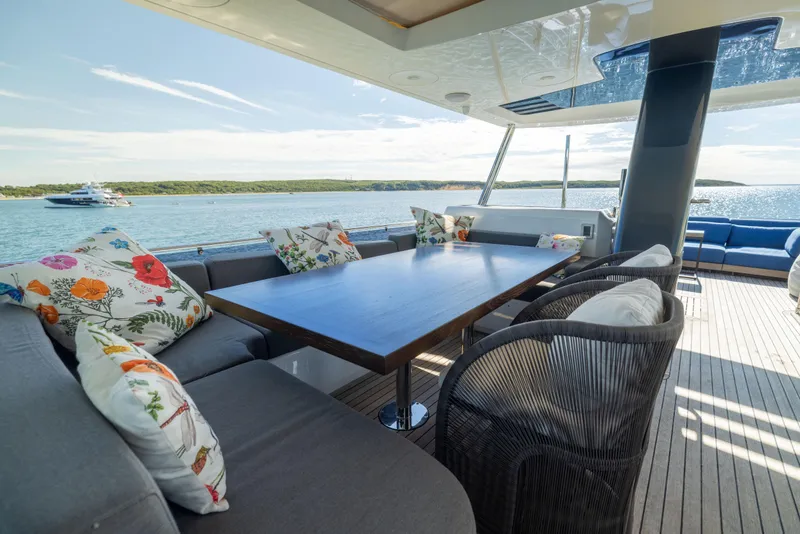 Slide: The Image of Luxurious 2019 Sirena 64 yacht deck with elegant seating and scenic ocean view. - 90