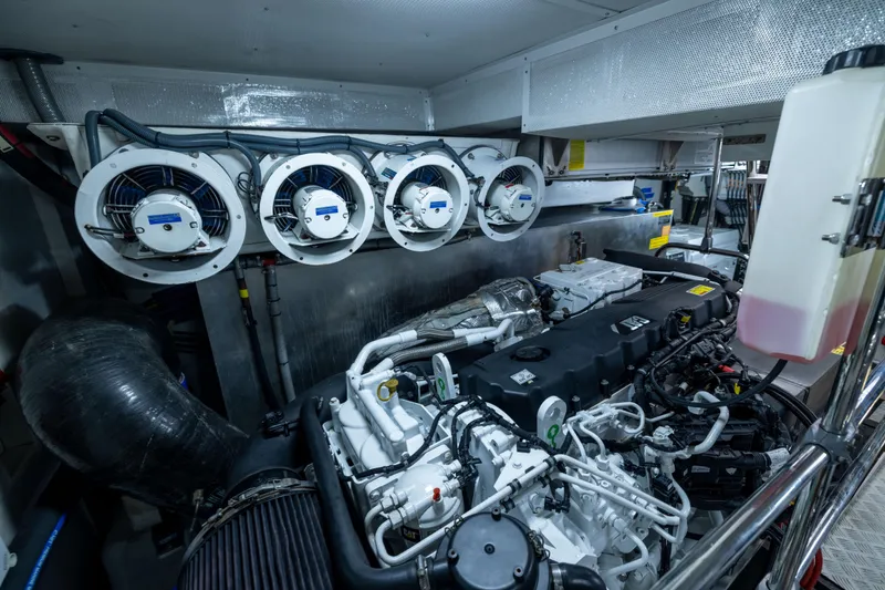 Slide: The Image of Engine room of a 2019 Sirena 64 yacht, showcasing advanced machinery and ventilation systems. - 97
