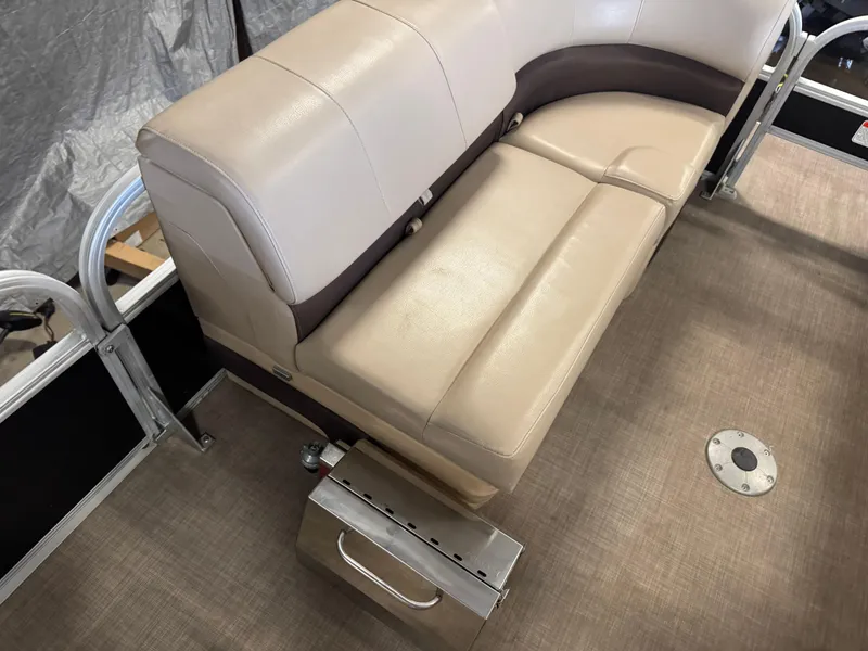 Slide: The Image of 2019 Sun Tracker SportFish 22 XP3 boat interior with beige seating and metal fixtures. - 10