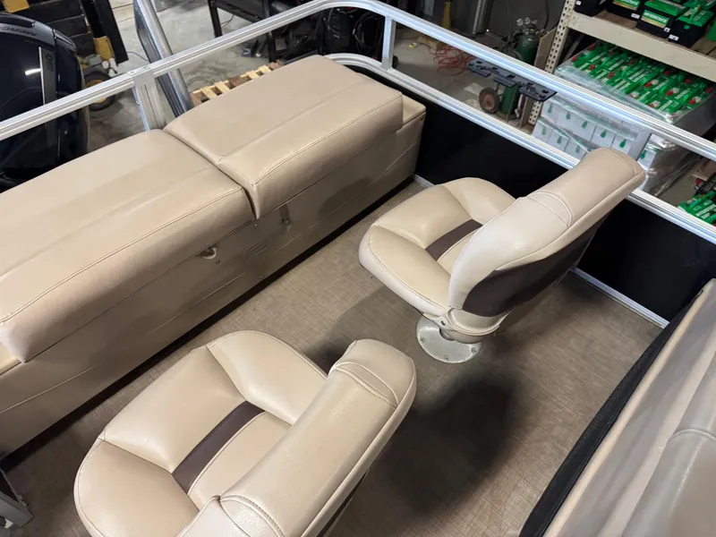 Slide: The Image of Interior of 2019 Sun Tracker SportFish 22 XP3 with beige seating and storage compartments. - 11