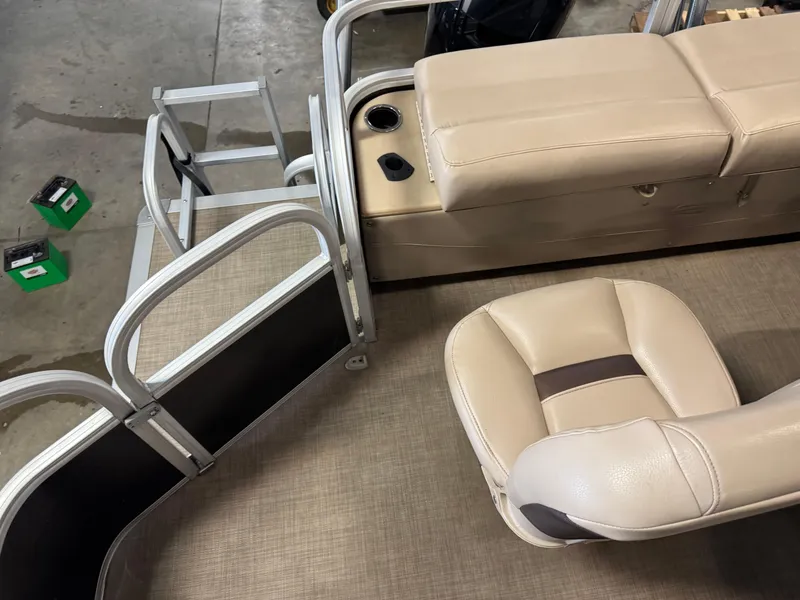 Slide: The Image of 2019 Sun Tracker SportFish 22 XP3 interior with beige seating and entry gate. - 12